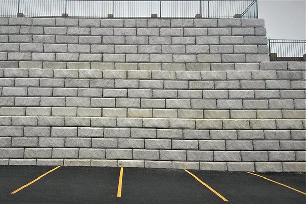 Parking lot retaining wall using J&R Precast 60 inch gravity blocks
