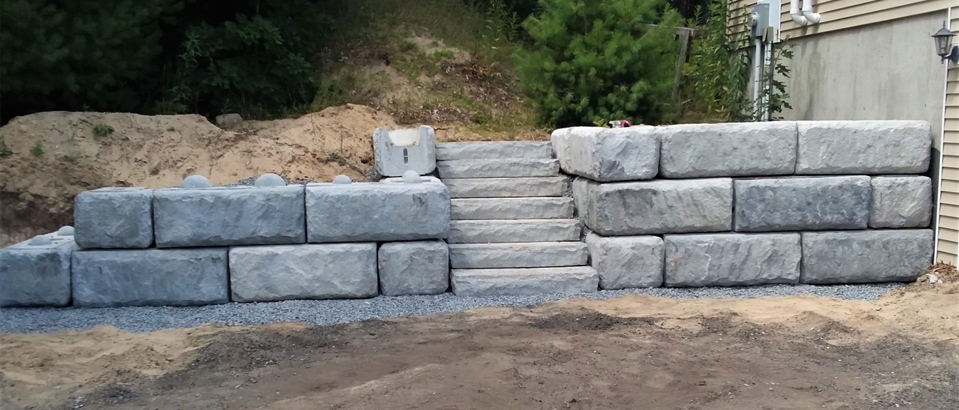 Residential Redi-Rock retaining wall featuring stairs